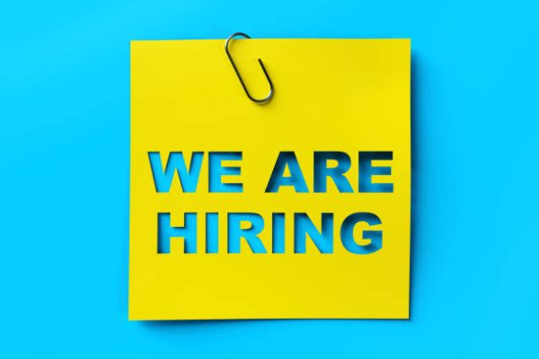 "We are hiring" yellow banner on blue textured background